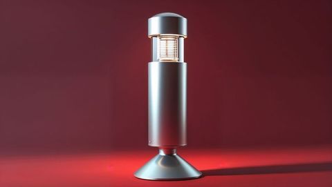 Sleek metal lamp casting ambient glow on red background