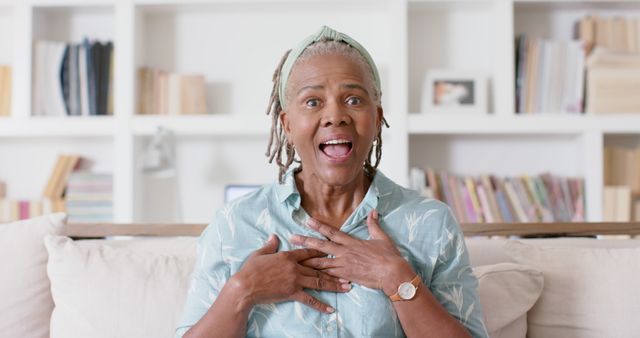 Senior Woman Reacting with Surprise While Sitting on Couch - Download Free Stock Images Pikwizard.com