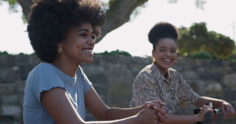 Delighted Twins on Scooters Enjoying Sunny Day Outdoors