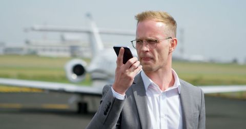 Businessman Handling Calls at Airport Runway - Download Free Stock Images Pikwizard.com