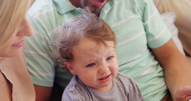 Parents Comforting Their Unhappy Toddler at Home - Download Free Stock Images Pikwizard.com