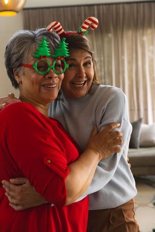 Middle Aged Friends Celebrating Festive Season Indoors