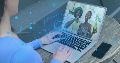 Typing on laptop securing video call with digital padlock overlay for remote work security