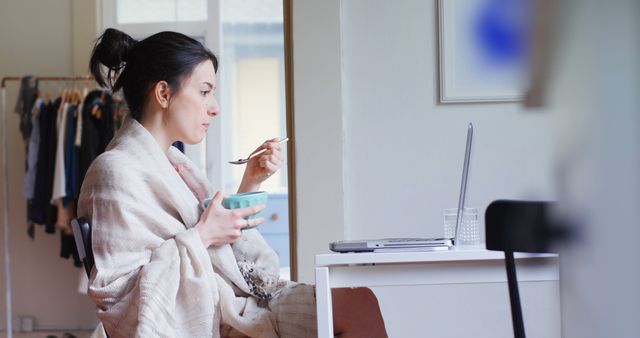 Young Woman Eating Breakfast While Working from Home - Download Free Stock Images Pikwizard.com