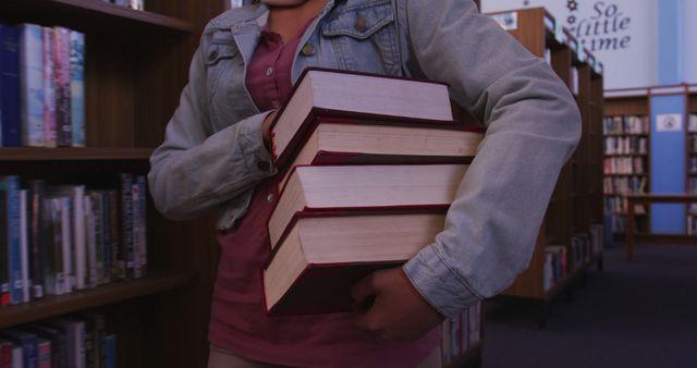 Person Holds Stack of Books in Library - Download Free Stock Images Pikwizard.com