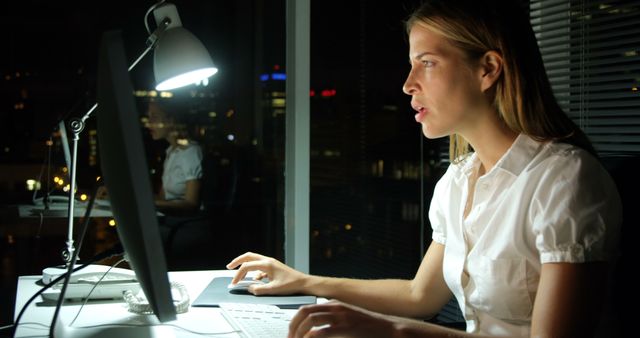 Focused Businesswoman Working Late at Night on Desktop Computer - Download Free Stock Images Pikwizard.com