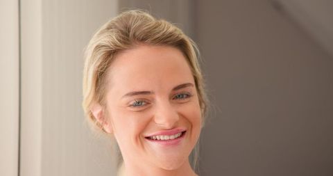 Serene Smiling Woman in Soft Neutral Lighting