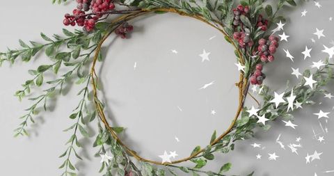 Frosted red berry wreath with greenery and star confetti minimal holiday centerpiece