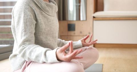 Woman Meditating Cross-Legged at Home in Cozy Attire