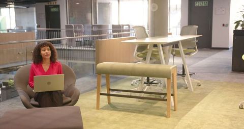 Modern Workspace with Woman Working on Laptop in Stylish Office