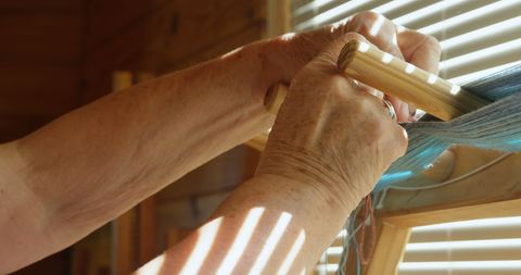 Senior Artisan Crafting at Hand Loom with Natural Light