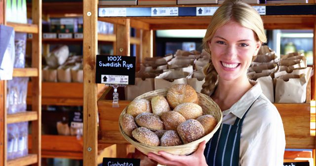 Smiling Female Baker Holding Basket of Freshly Baked Bread Rolls in Bakery - Download Free Stock Images Pikwizard.com