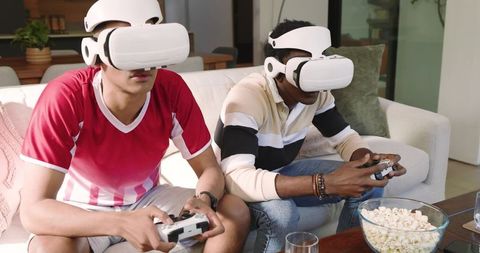Young men enjoying vr gaming with popcorn in living room