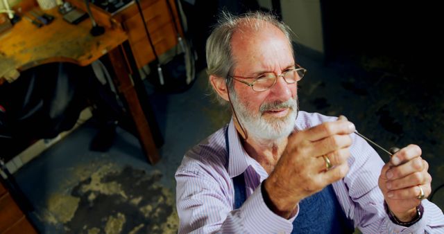 Senior Jewelry Artisan Inspecting Craftsmanship in Workshop - Download Free Stock Images Pikwizard.com