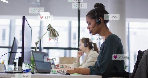 Businesswomen engaged in customer support with digital data overlays