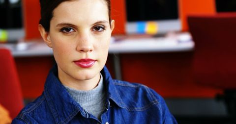 Professional Woman in Denim Posing Confident in Modern Office