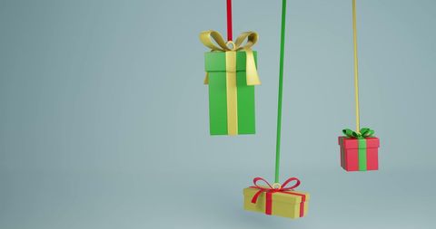 Hanging christmas gifts on ribbon with neutral background