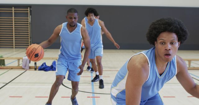 Basketball Players Practicing Indoors in Blue Jerseys - Download Free Stock Images Pikwizard.com