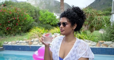 Relaxing by pool with grapefruit spritzer and white crochet cover-up