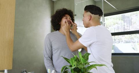 Friends Sharing Skincare Routine in Bathroom Either Natural Vibes