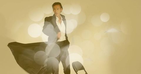 Elegant asian man in black suit with bokeh lights