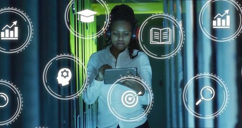Tech professional woman analyzing data in server corridor
