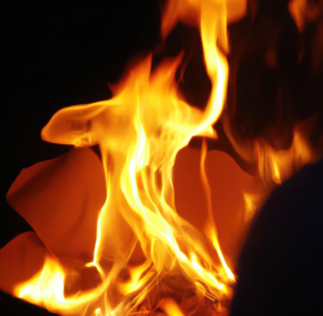 Close up of burning paper with fire on black background, created using generative ai technology. Nature and fire concept, digitally generated image.