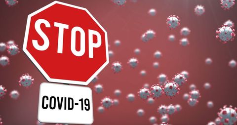 Stop COVID-19 Concept with Floating Virus Cells and Sign
