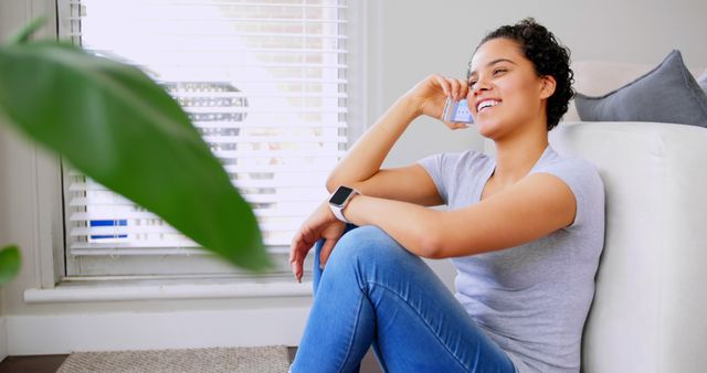 Smiling Young Woman Talking on Smartphone Sitting at Home - Download Free Stock Images Pikwizard.com