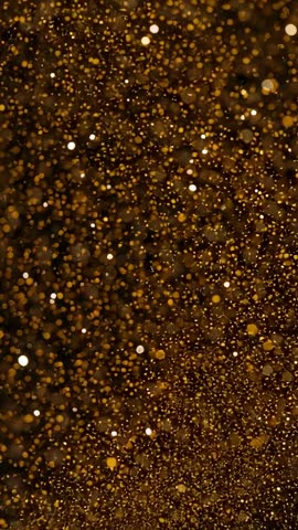 Golden bokeh particles drifting and shifting focus in vertical studio video loop overlays