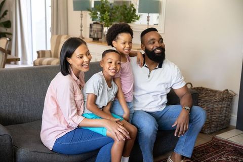 Happy family sitting together in bright living room