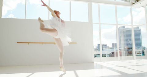 Elegant Ballet Dancer Performing Graceful Jump in Sunlit Studio - Download Free Stock Images Pikwizard.com