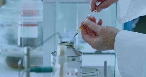 Senior scientist handling syringe with precision and expertise