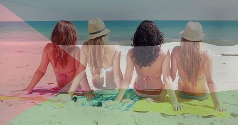 Four Women Enjoy Relaxing Summer Day on Vibrant Beachfront
