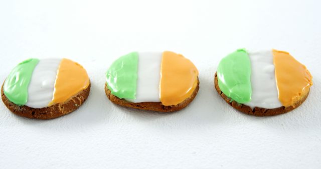 These cookies are decorated with icing in the colors of the Irish flag—green, white, and orange—making them perfect for celebrating St. Patrick's Day. Ideal for social media posts about holiday celebrations, baking blogs, or advertising St. Patrick's Day events. Use in materials promoting seasonal themed activities and recipes.