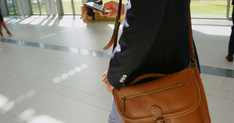 Businessman in Office Using Mobile Phone