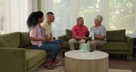 Family Gathering Grandparents Receiving Baby Gift