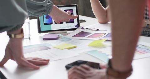 Collaborative Team Discussing Mobile App Design with Color Samples - Download Free Stock Images Pikwizard.com