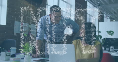 Colleagues Collaborating on NFT Project in Modern Office