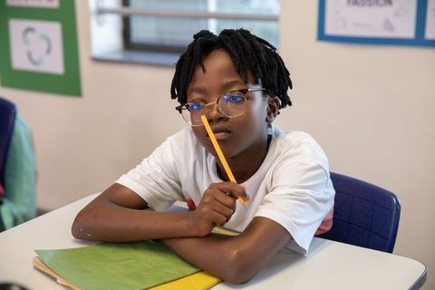 Focused Student Studying in Classroom