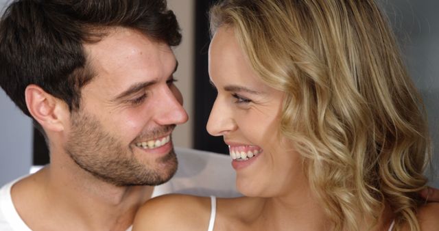 Couple embracing in bed in bedroom