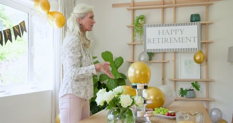 Senior Woman Arranging Table for Retirement Celebration