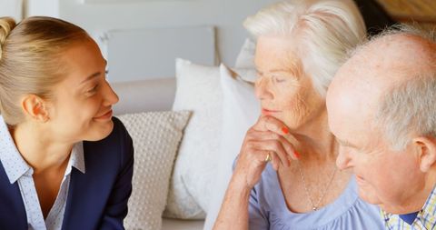 Real Estate Agent Consults with Senior Couple at Home