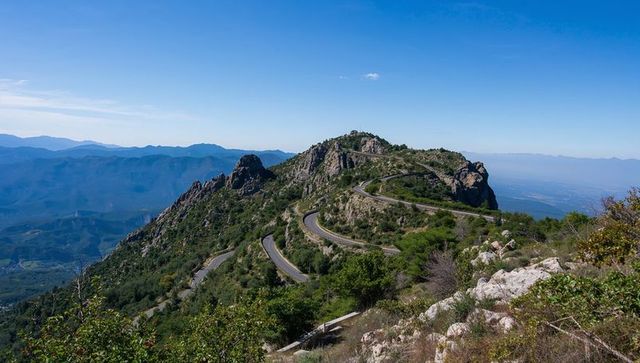 Scenic mountain pass with serpentine road and rock formations