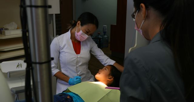 Female Dentist Treating Young Patient in Dental Office - Download Free Stock Images Pikwizard.com