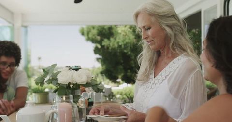 Women Celebrating Bridal Shower with Tea and Conversation Outdoors