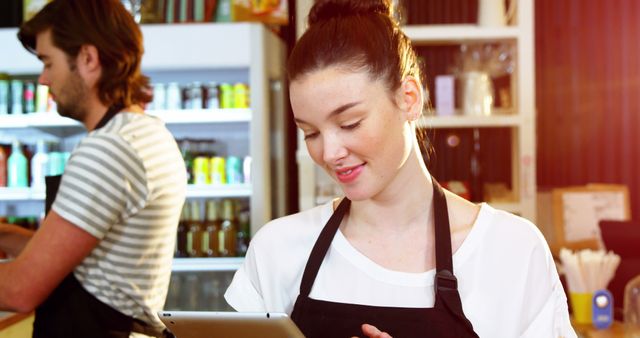 Smiling Barista Using Digital Tablet in Cafe - Download Free Stock Images Pikwizard.com