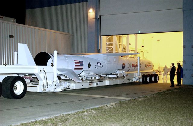 The Pegasus launch vehicle is seen entering the Multi-Payload Processing Facility at Kennedy Space Center. It is being prepared to carry the Galaxy Evolution Explorer (GALEX) into orbit. This space telescope will observe galaxies in ultraviolet light, unveiling details about 10 billion years of cosmic history. Such imagery is useful for illustrating space missions, aerospace engineering, satellite preparation, and astronomical research in educational materials or news articles.