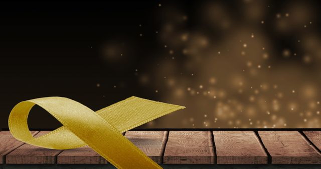 Yellow Ribbon on Wooden Surface with Sparkling Lights Background - Download Free Stock Images Pikwizard.com