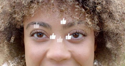 Close-up curly woman with thumbs-up overlays representing social media likes